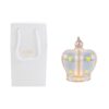 Corona in porcellana LED celeste 9x8x4,5 cm accesa accanto a shopper bianco con dettagli decorativi dorati.