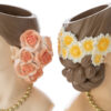 Vasi decorativi a forma di testa femminile in resina, con fiori rosa e gialli tra i capelli. Dimensioni: 13,5x10,5xh.18,5 cm.